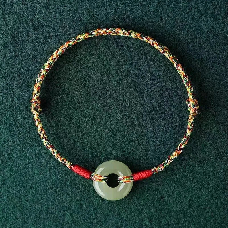 Colourful braided rope bracelet with silver peace buckle on woven wristband