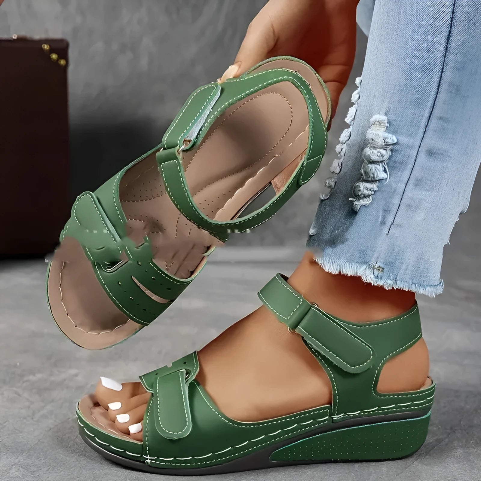 Women's beige strap sandals with a Velcro fastener and thick composite sole, shown in a round toe design.