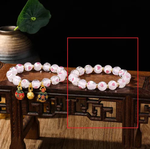 Handmade glass bracelet with swallowing gold beast design and cherry blossom heart in six colours.