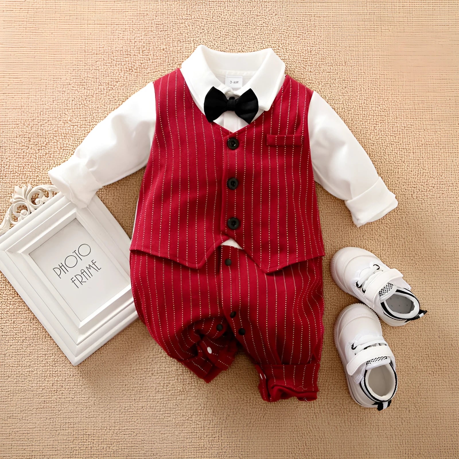 Baby boy wearing a wine red long-sleeved gentleman-style cotton jumpsuit with single-breasted closure.