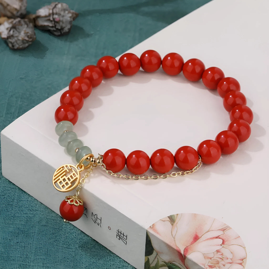 Retro red sand cinnabar bracelet with fu character charm, jade ornament, and 8mm tassel