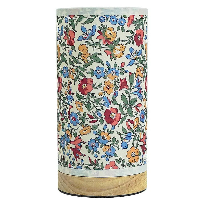 Creative USB table lamp with fabric shade in blue butterfly pattern on modern desk