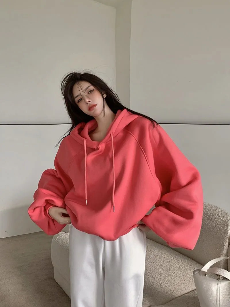 Watermelon red women's sleeveless hooded sweater made from mulberry silk, shown loose fit.