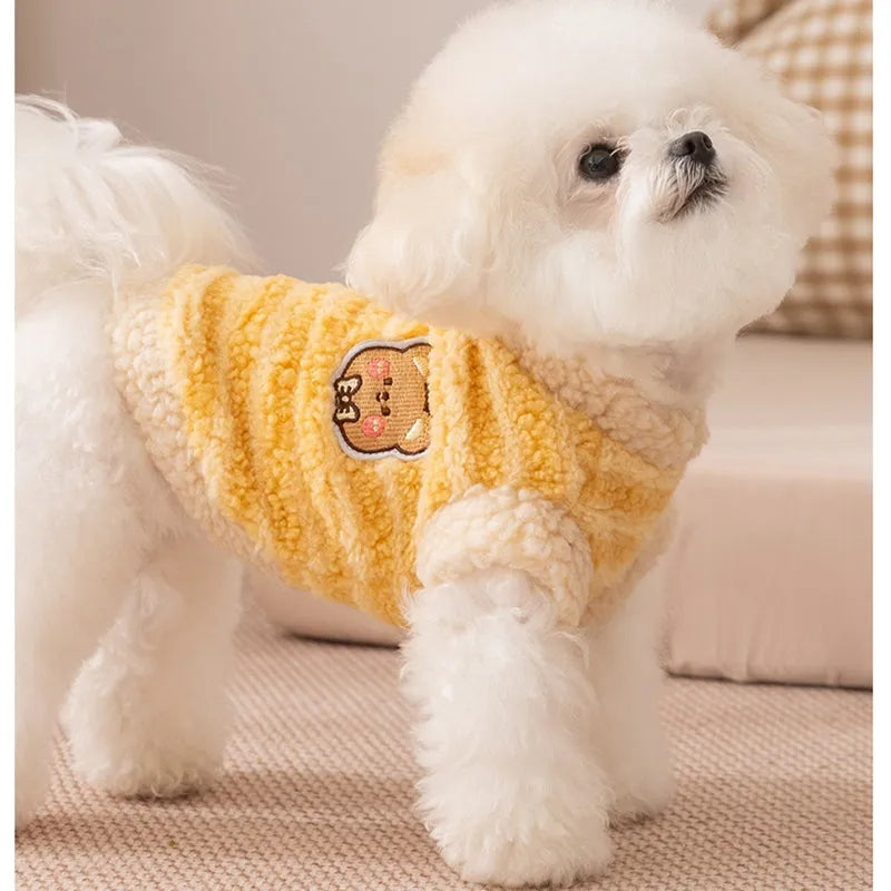 Blue striped lambskin fleece dog coat with drawstring and leash ring on a small dog against a neutral background