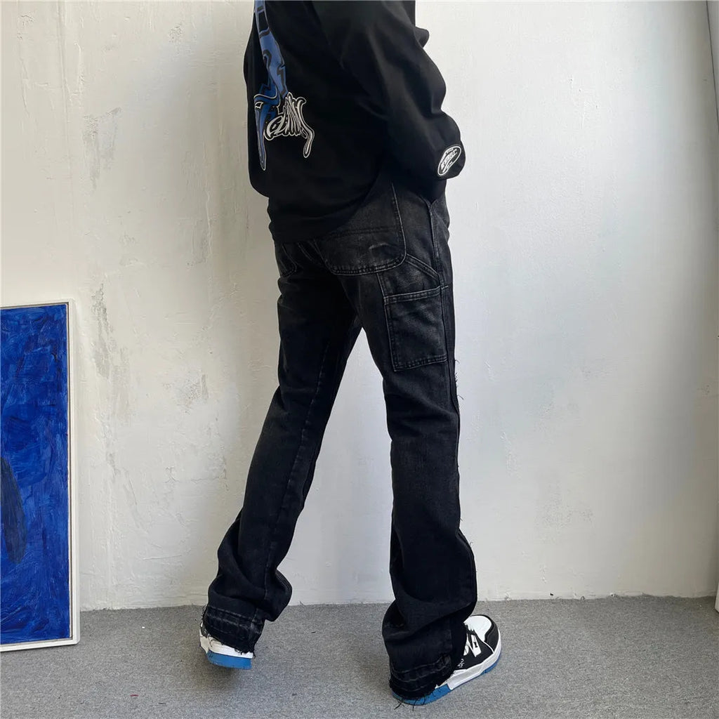 Black micro flared patchwork raw edge jeans on model showing loose straight tube fit