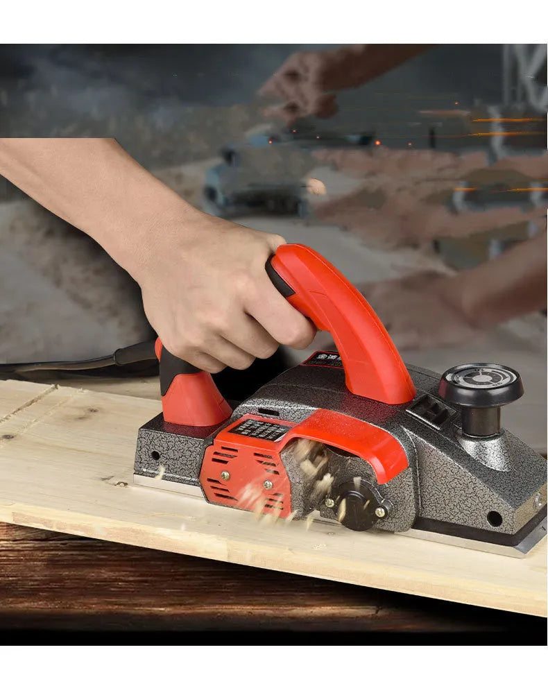Red desktop electric wood planer with aluminium body showing 82mm planing width