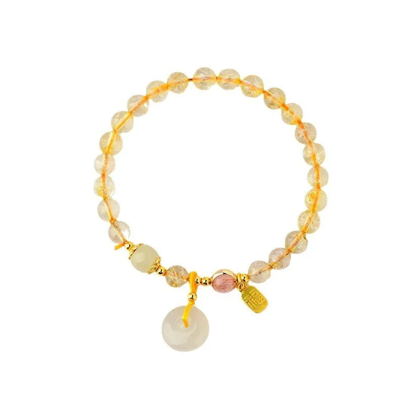 Gold rutilated quartz crystal bracelet with safety buckle and geometric national style design featuring blessing card pendant.