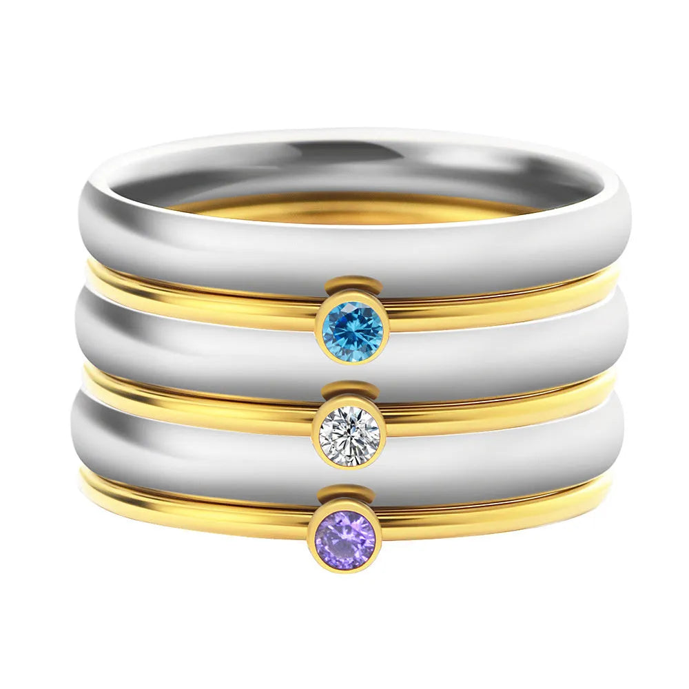 Geometric titanium steel ring with engraved December birthstones in a superimposed design on a hand.