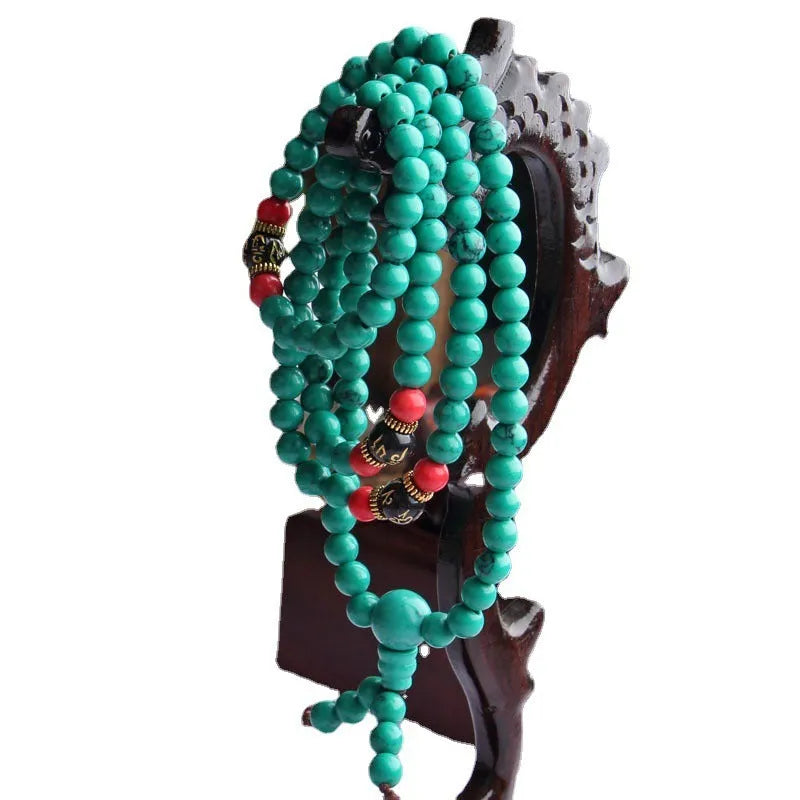 Turquoise 108-bead mala bracelet with polished round synthetic stone powder beads.