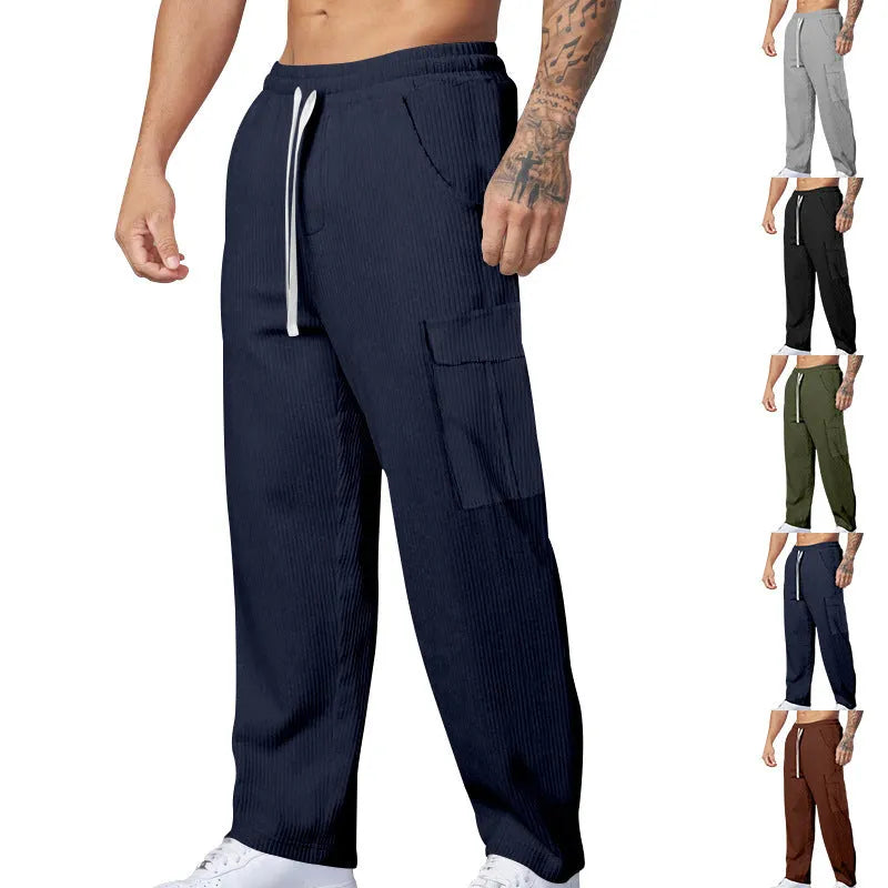 Men's loose-fitting corduroy cargo trousers in navy blue with a drawstring waist and straight wide legs.