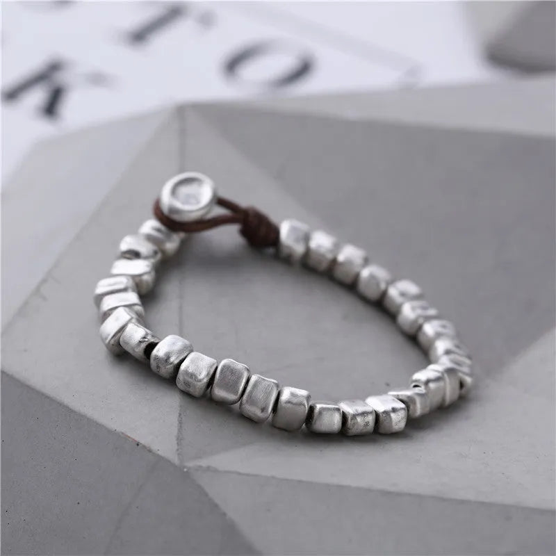 Handmade silver women's bracelet with wooden accents and irregular square design