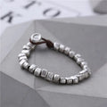 Handmade silver women's bracelet with wooden accents and irregular square design