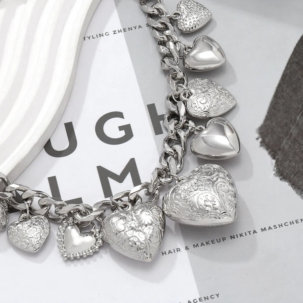 Close-up of a women's exaggerated carved heart pendant necklace on an adjustable metal chain.