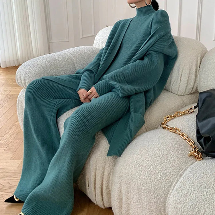 Women's apricot knitted three-piece set featuring a cardigan, sweater, and wide-leg trousers on a hanger.