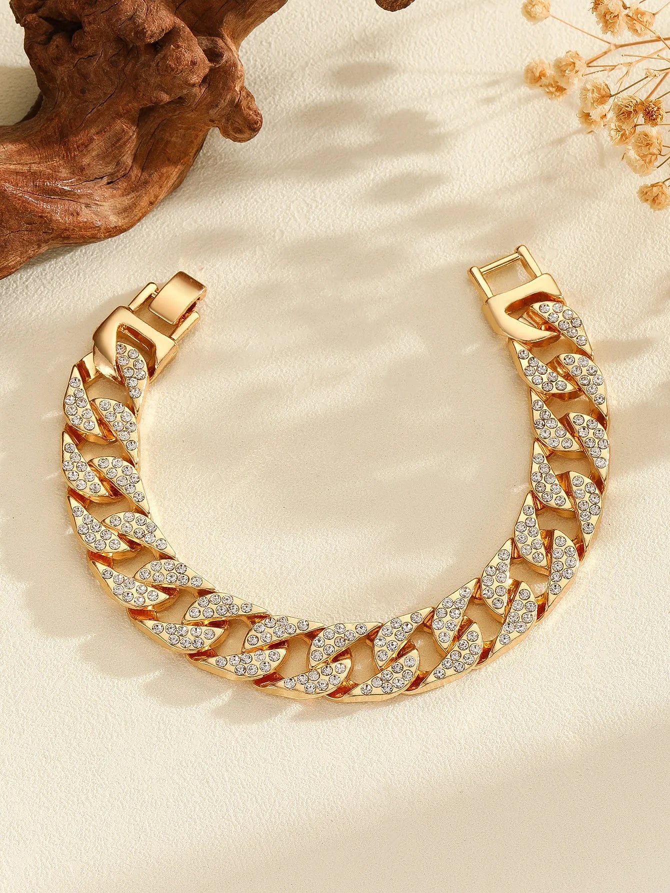 Full diamond heavy metal rap bracelet in gold with chunky link construction and diamond cut surface.