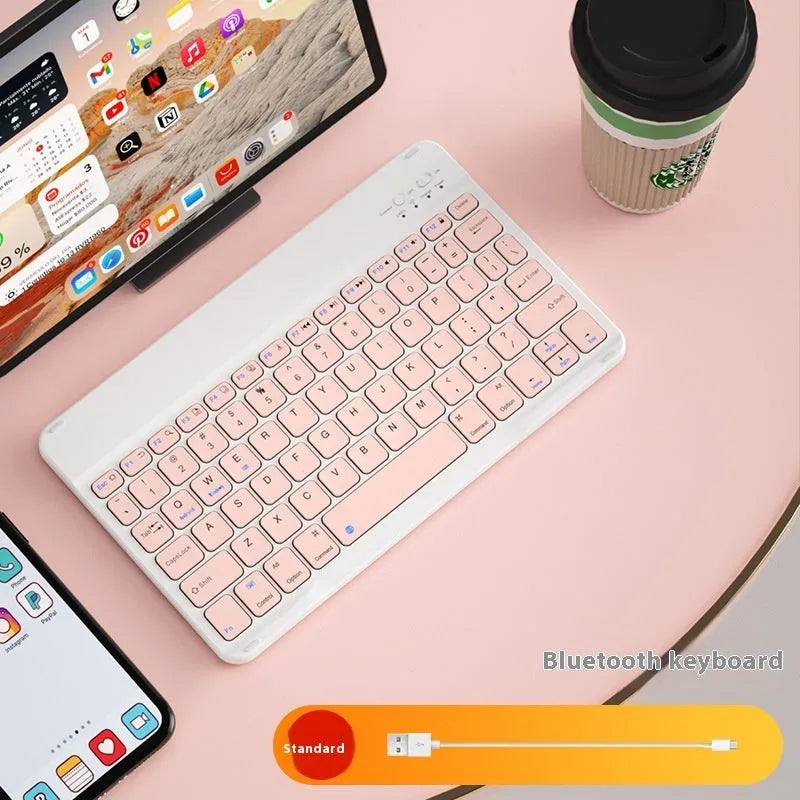 Girls Bluetooth keyboard in Lavender colour on a desk next to a tablet