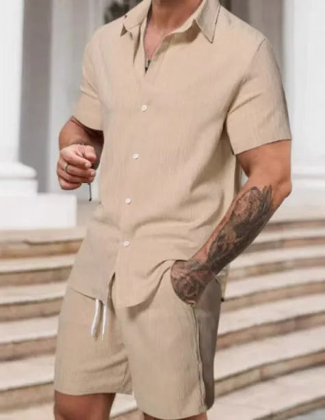 A man wearing a striped short-sleeve shirt and matching shorts from a casual suit set.