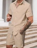 A man wearing a striped short-sleeve shirt and matching shorts from a casual suit set.
