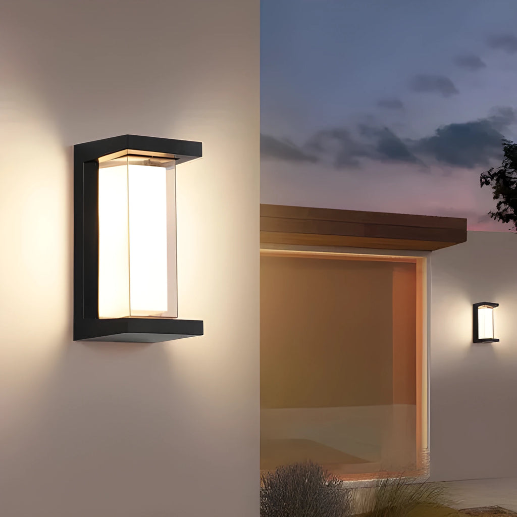 Waterproof IP65-rated outdoor wall lamp with aluminium body and acrylic shade, shown in a garden setting.