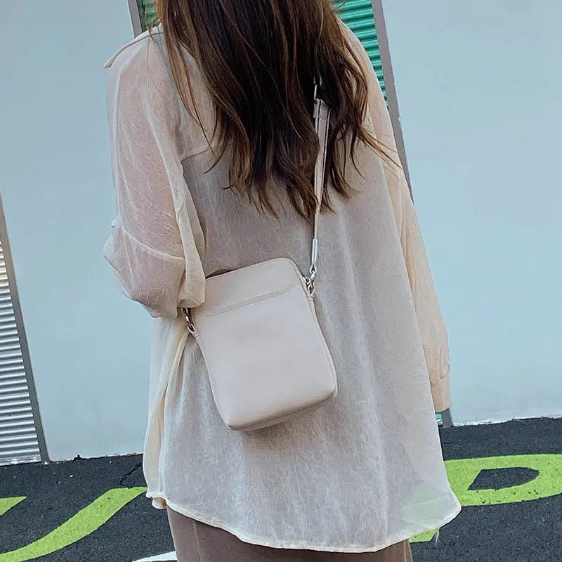 Small solid colour PU leather crossbody shoulder bag for mobile phone in beige.