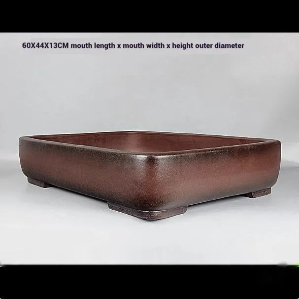 Large rectangular antique purple clay flower pot for indoor plants on a tabletop.