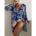 Women's floral patterned tight bikini three-piece swimsuit set with a coat on a hanger.