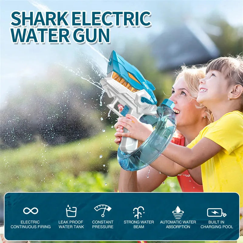 Blue Shark-shaped electric water gun toy with a large tank, placed on a sandy beach.