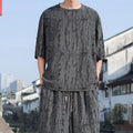 Men's thin black knitwear short-sleeve suit with cropped trousers on hanger