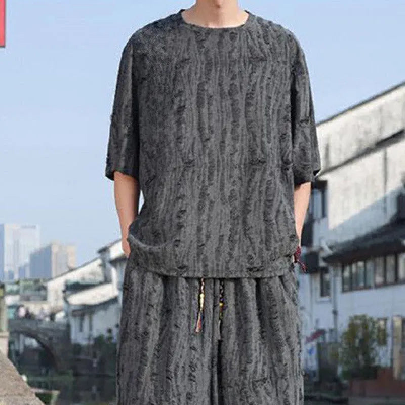 Men's thin black knitwear short-sleeve suit with cropped trousers on hanger