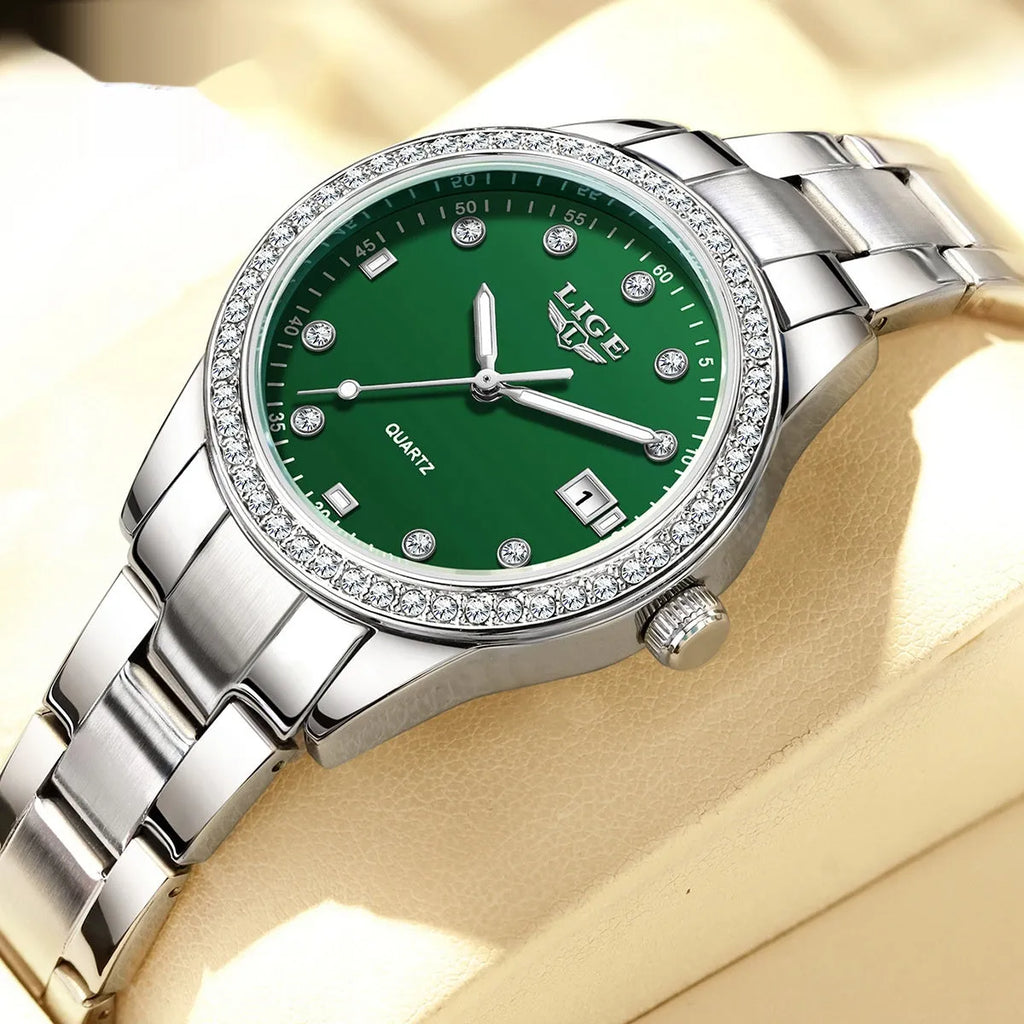 Silver stainless steel ladies watch with diamond-encrusted bezel and round blue dial.