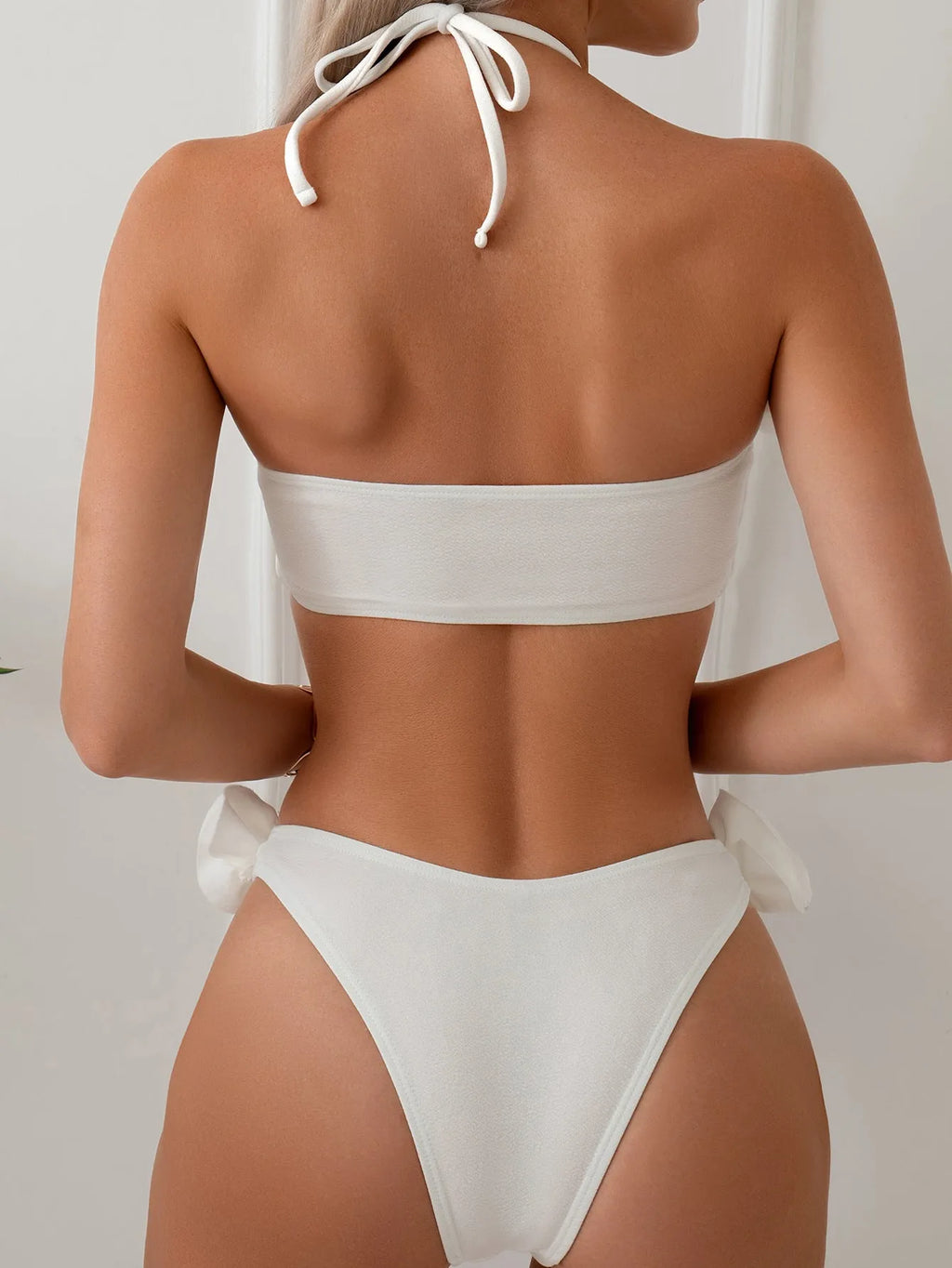 White women's halter lace-up bikini with three-dimensional floral pattern and briefs