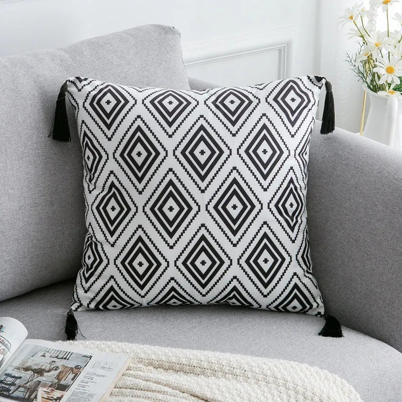 Bohemian national style throw pillow cushion cover in light grey on a sofa.