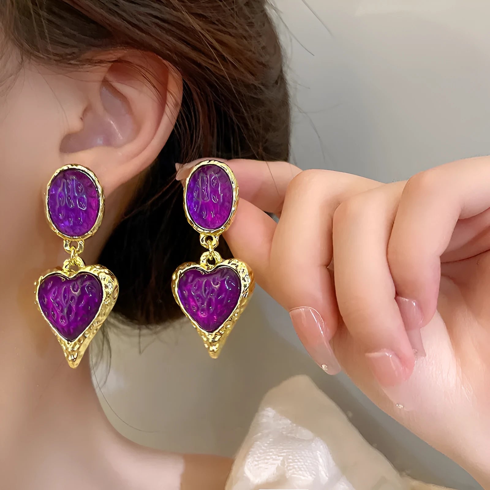 Oval heart-shaped alloy stud earrings with silver pleated edge, shown in purple, red, green, and yellow/white colour options.
