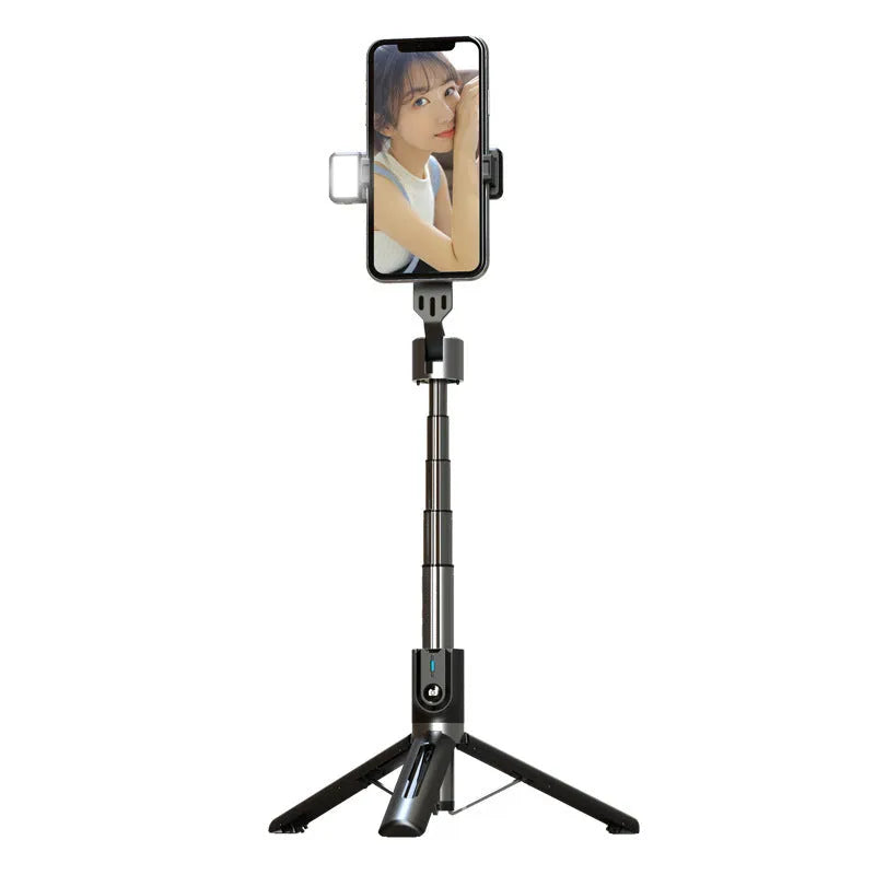 Black aluminium Bluetooth selfie stick with dual fill lights extended on a desktop.