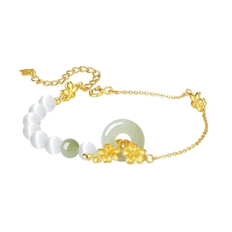 Women's silver peace buckle bracelet with floral design and safety closure mechanism in gold electroplated finish
