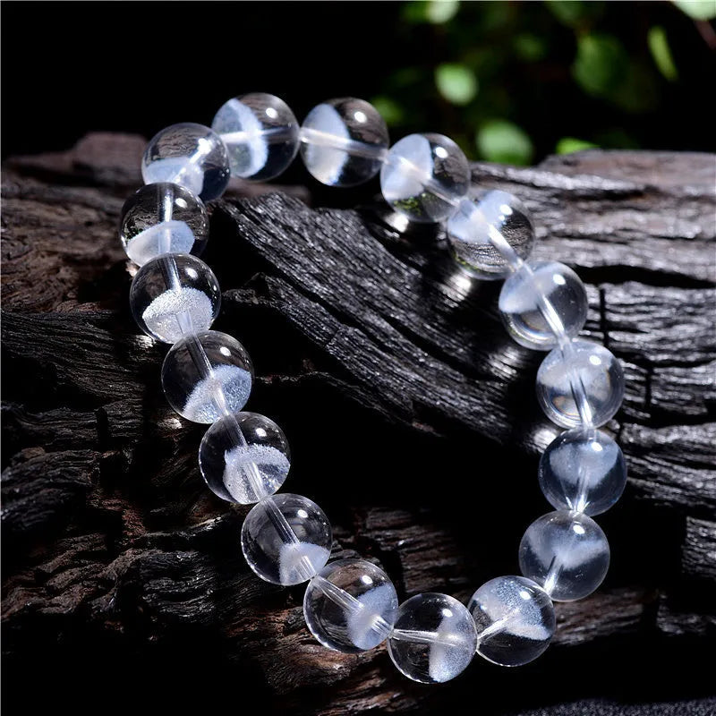 Women's white crystal bracelet with a ghost pyramid centrepiece and a traditional Ruyi charm.