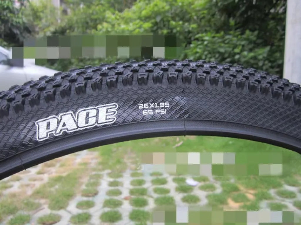 Ultralight mountain bike tyre with reinforced black sidewall shown next to size and weight specifications.
