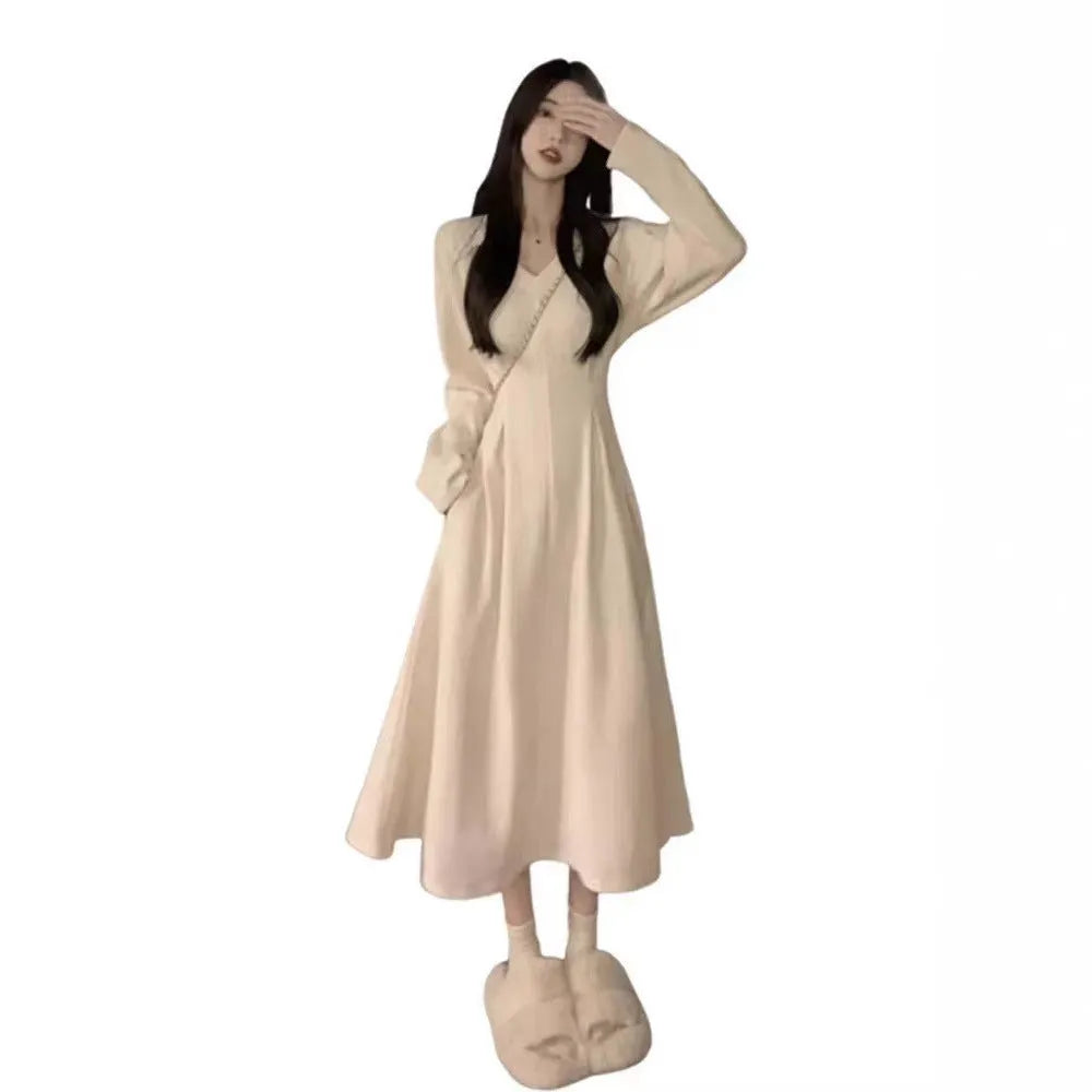Women's white V-neck knitted dress with long princess sleeves and suspender skirt silhouette