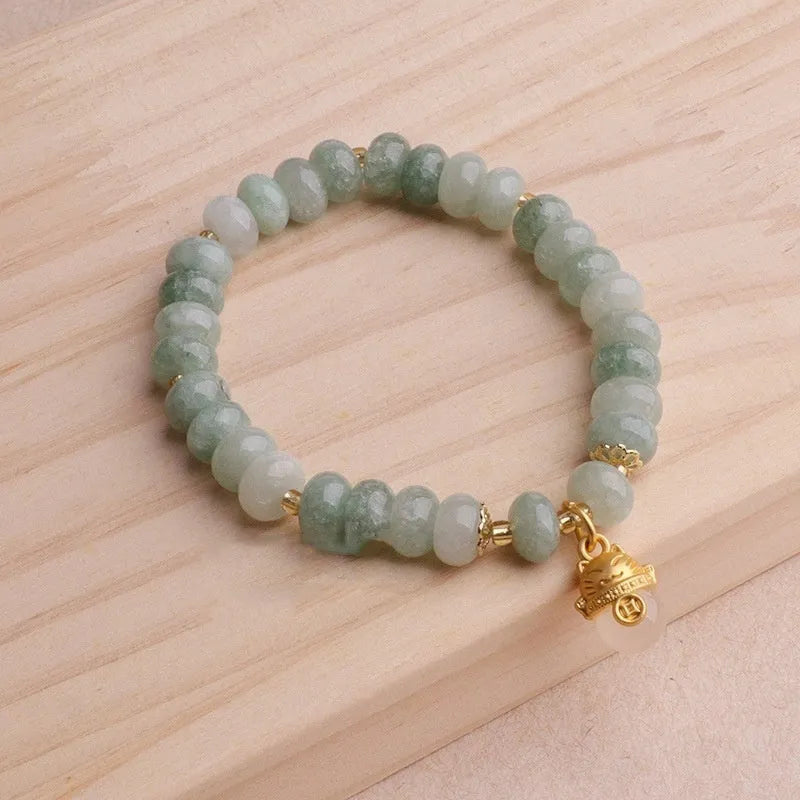 Women's strawberry quartz bracelet with a retro lucky cat charm in grey jade.