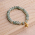 Women's strawberry quartz bracelet with a retro lucky cat charm in grey jade.