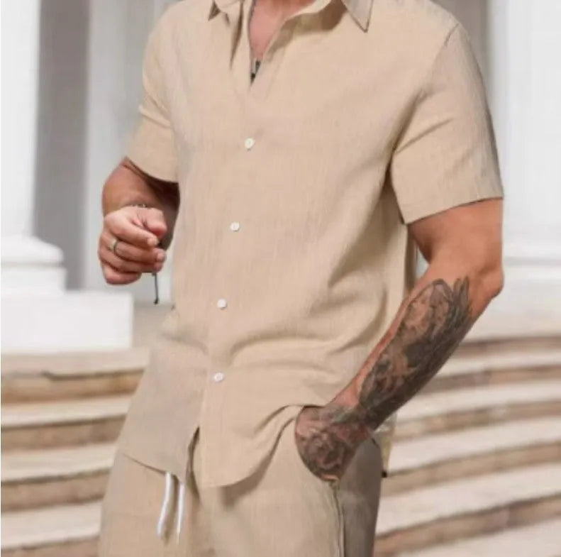 A man wearing a striped short-sleeve shirt and matching shorts from a casual suit set.
