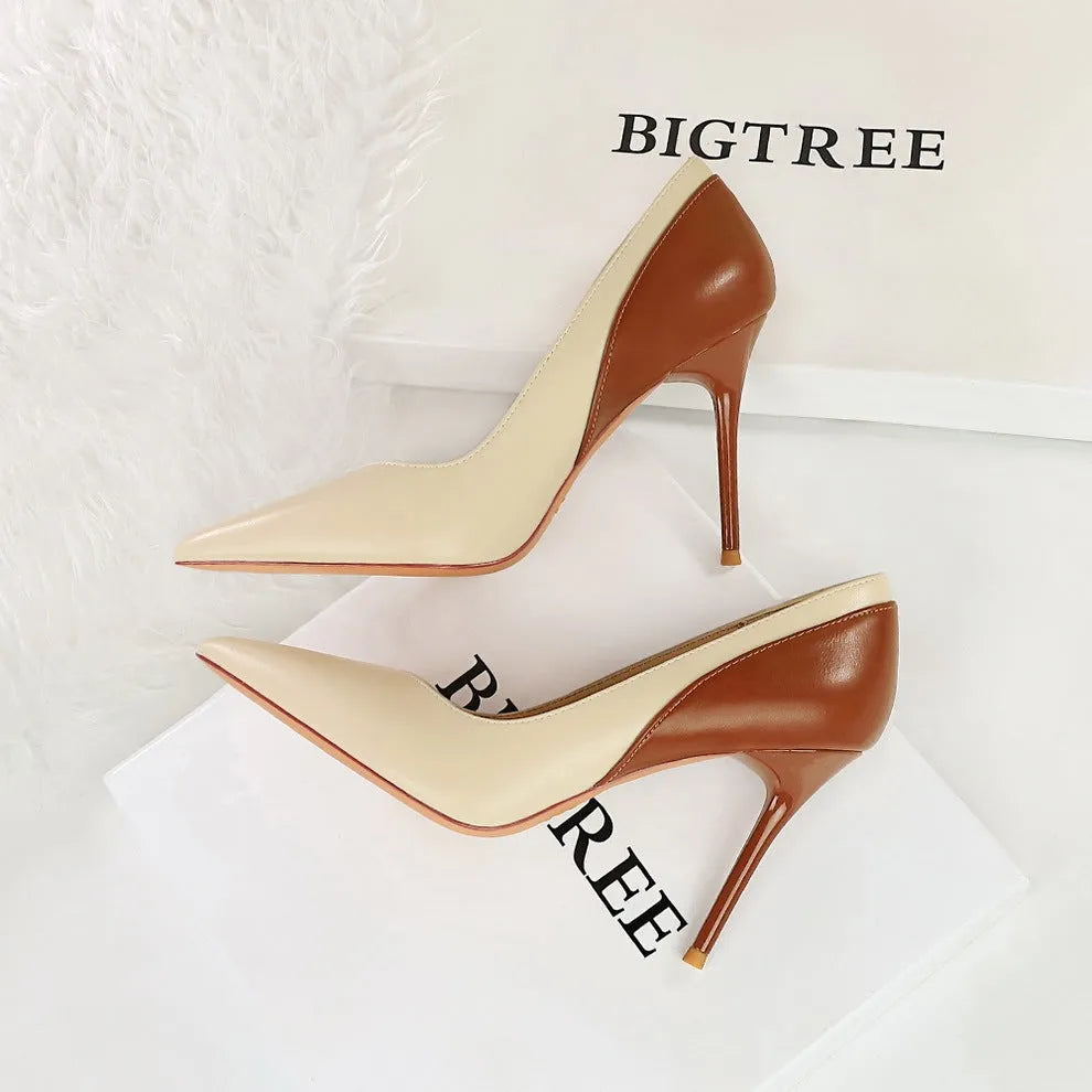 Retro-style black and creamy white women's stiletto high heels with pointed toe for banquet wear.