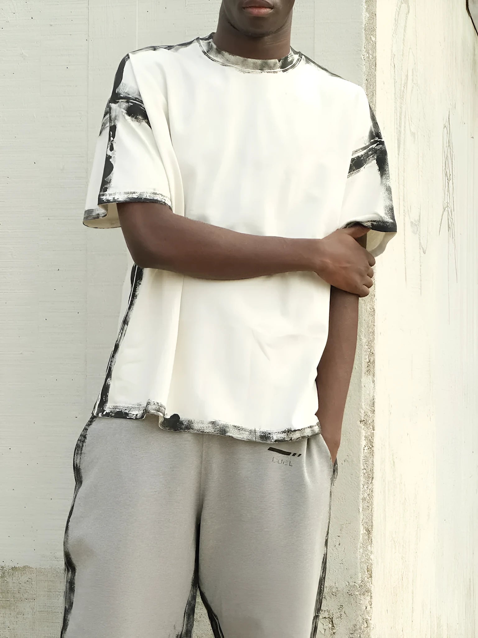 White casual short sleeve top with a draped design and printed detail.