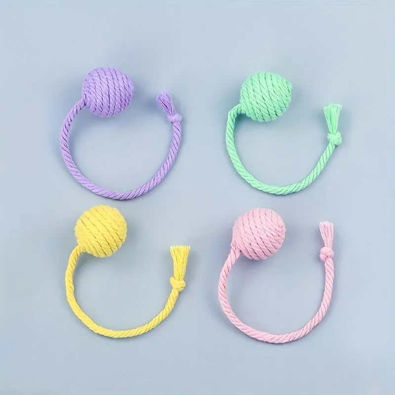 Cat toy ball with attached rope in green, pink, purple or yellow colours showing 3cm and 6cm size options