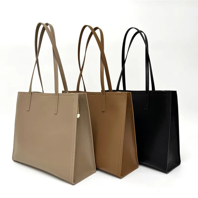 Brown genuine leather one shoulder handbag showing horizontal square shape and single strap.
