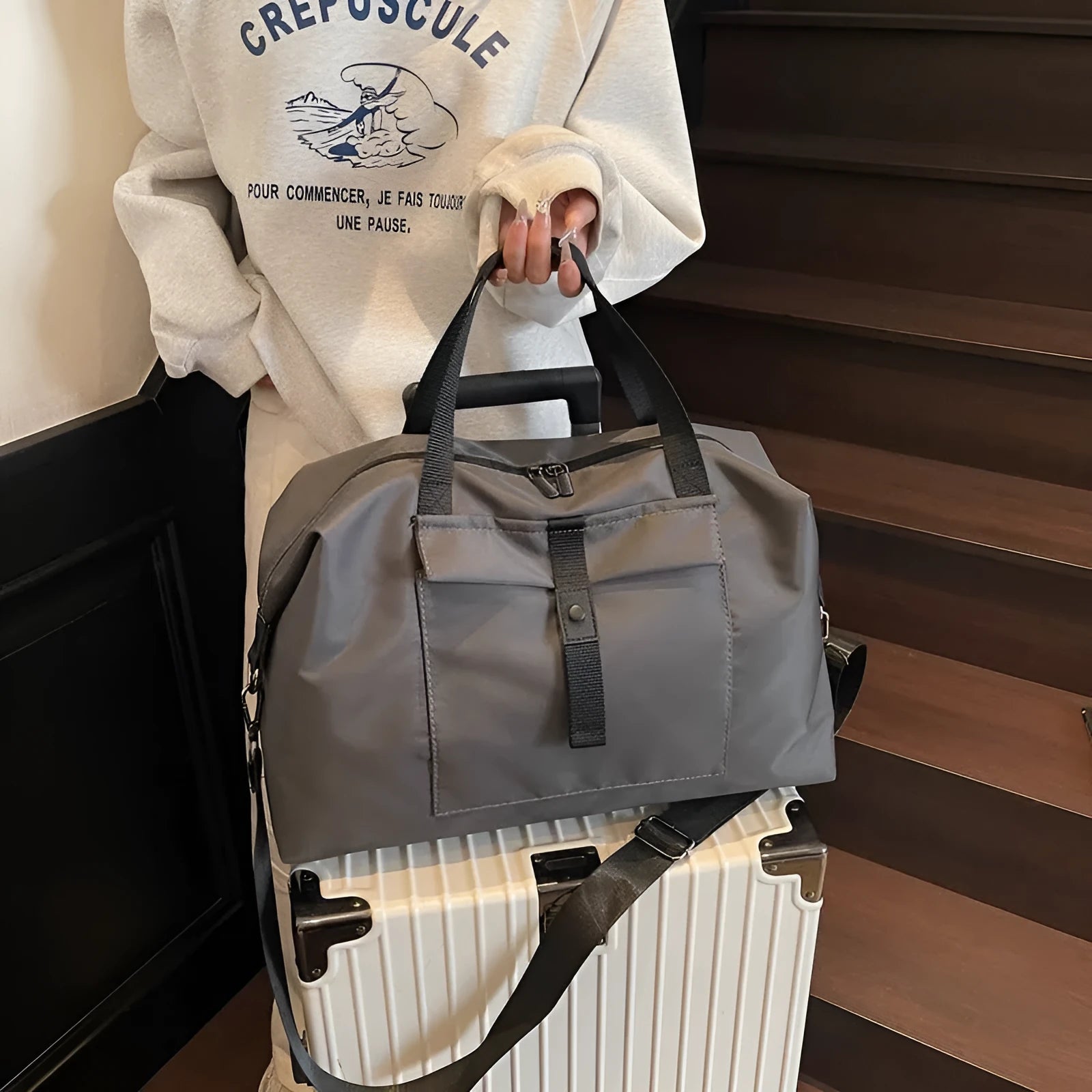 Grey one-shoulder travel bag with 36-55L capacity showing Oxford cloth construction