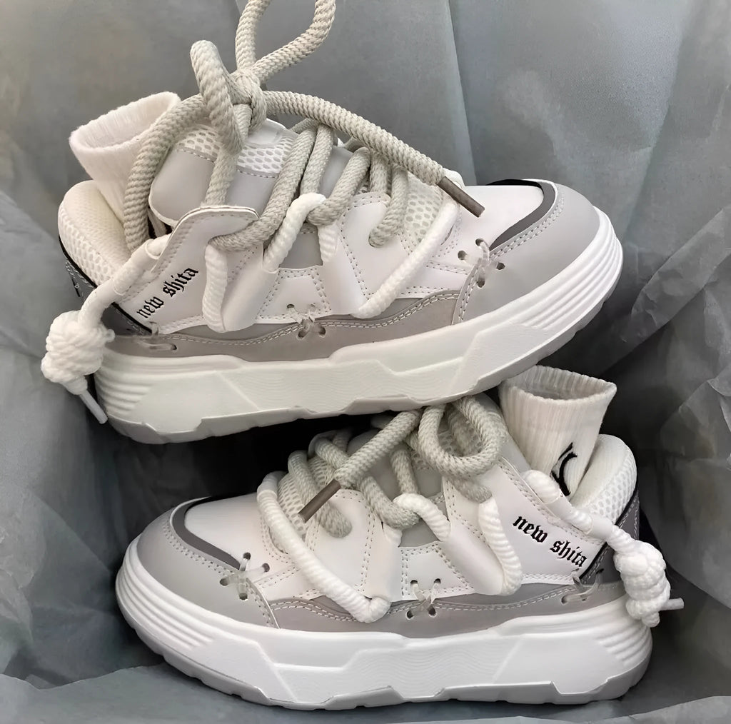 Women's thick sole grey retro sneakers with lace-up front and chunky rubber heel.