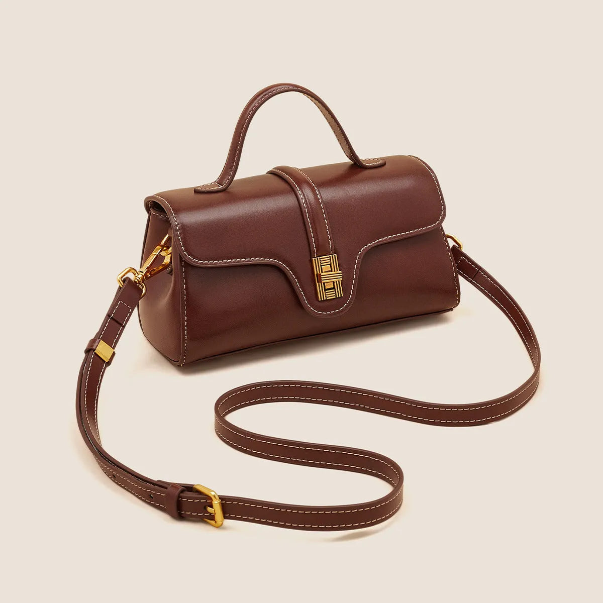 Cambridge-style leather messenger bag in clamshell design with lock detail and internal compartments