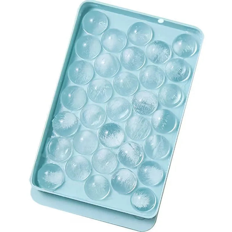 Blue silicone ice cube tray with lid showing 33 round holes for large ice cubes