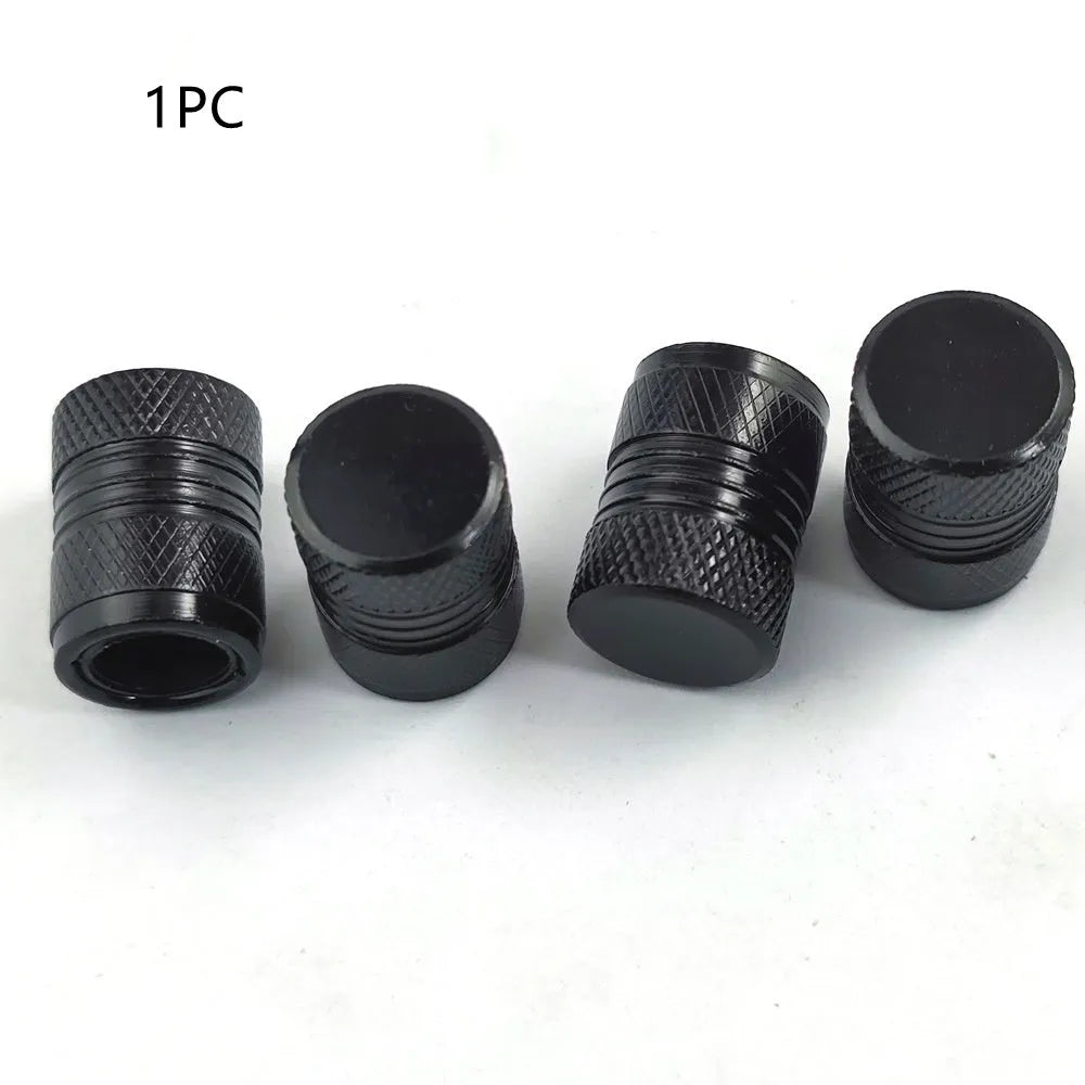 Aluminium car tyre valve dust cap in black, blue, grey, and red colours.